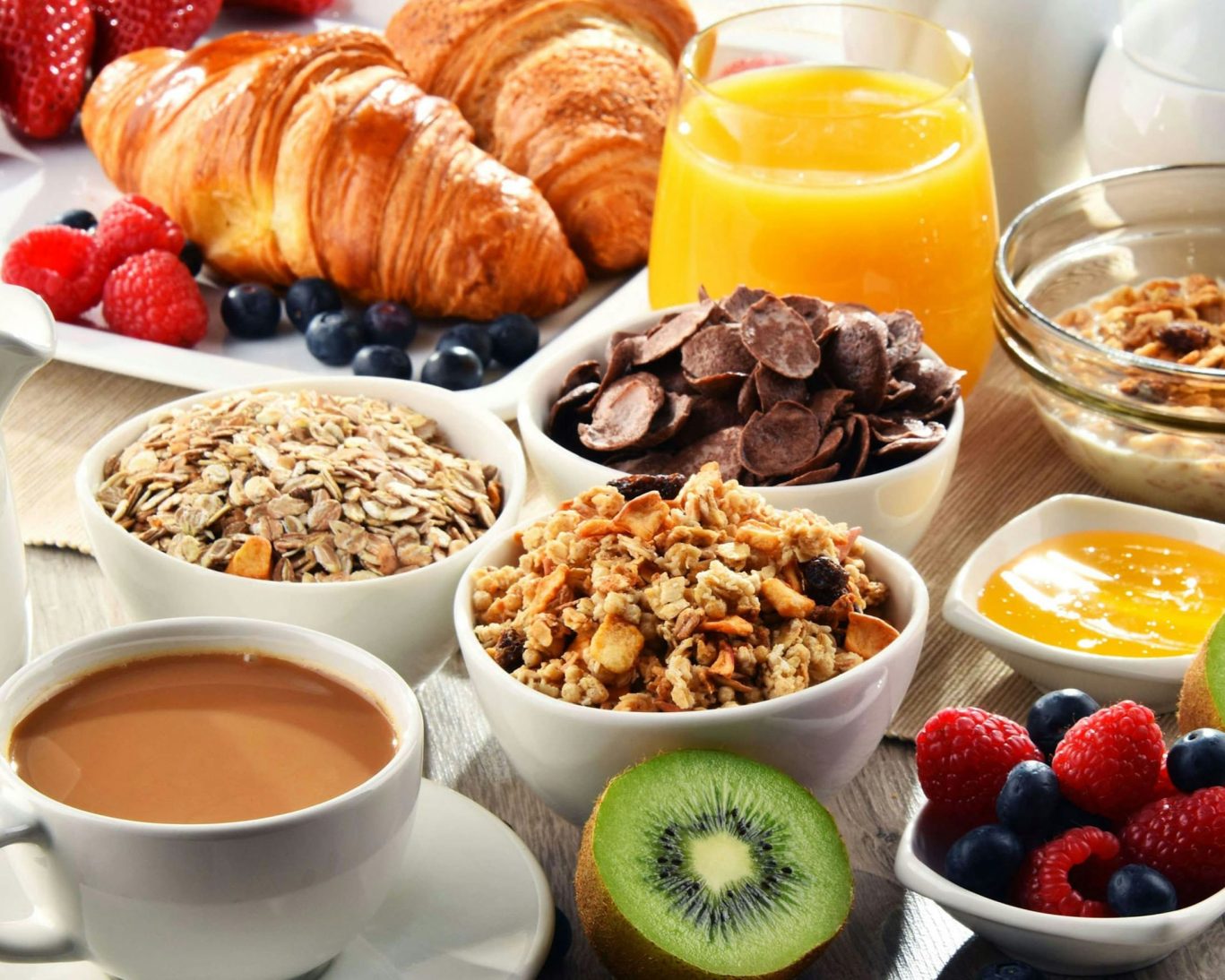 Continental breakfast spread with granola, croissants, fruit, juice, and coffee at Belmont Inn & Suites.