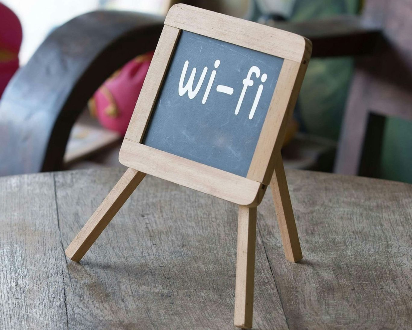 Chalkboard-style sign displaying free Wi-Fi at Best Travel Inn.