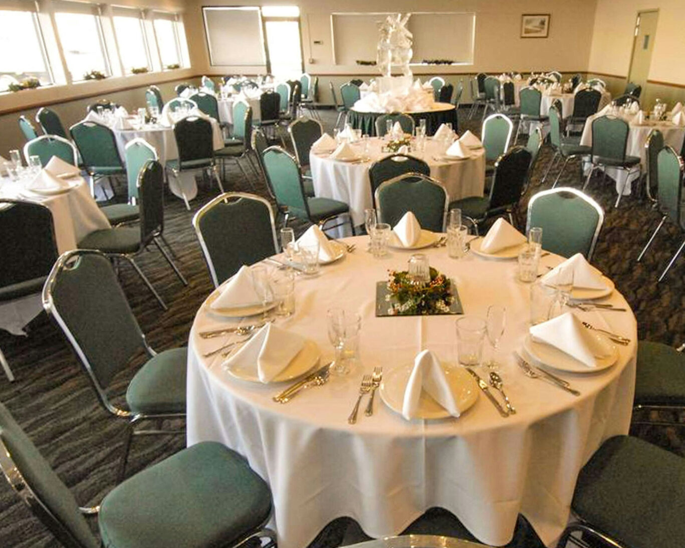 Elegant banquet hall setup for events at Broadway Inn with round tables and white linens