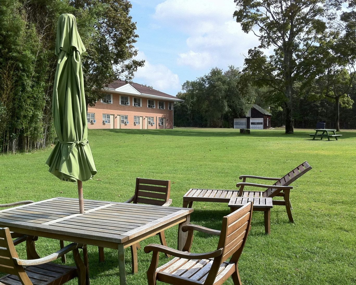 Spacious lawn and patio seating at Budget Host East End motel