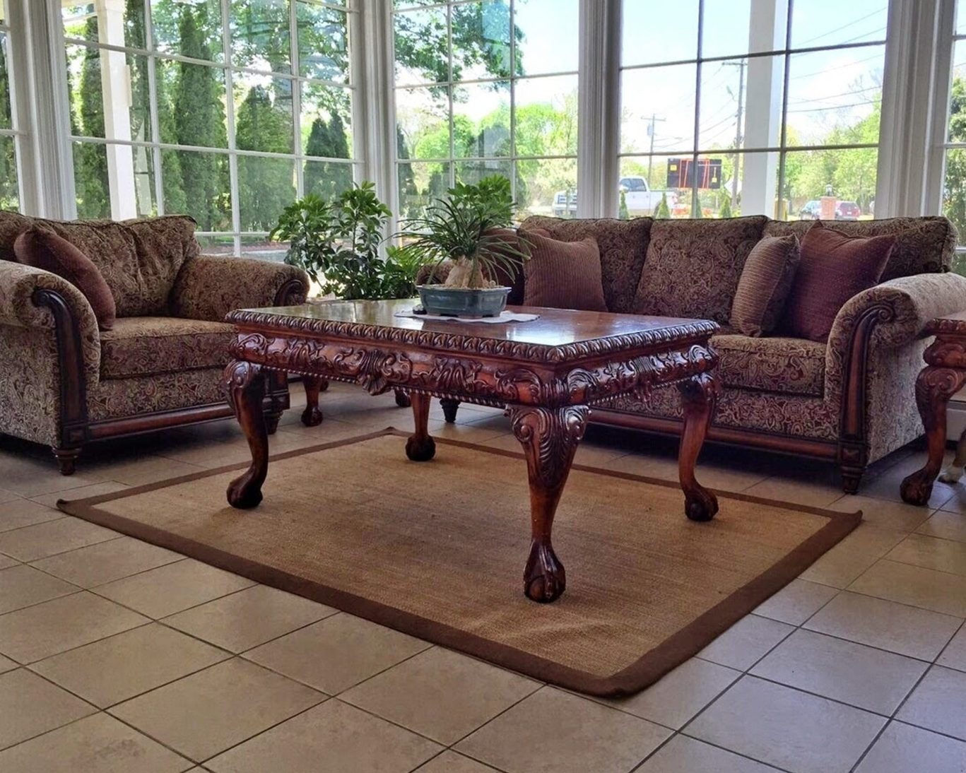 Lobby seating area at Budget Host East End with classic wooden furniture