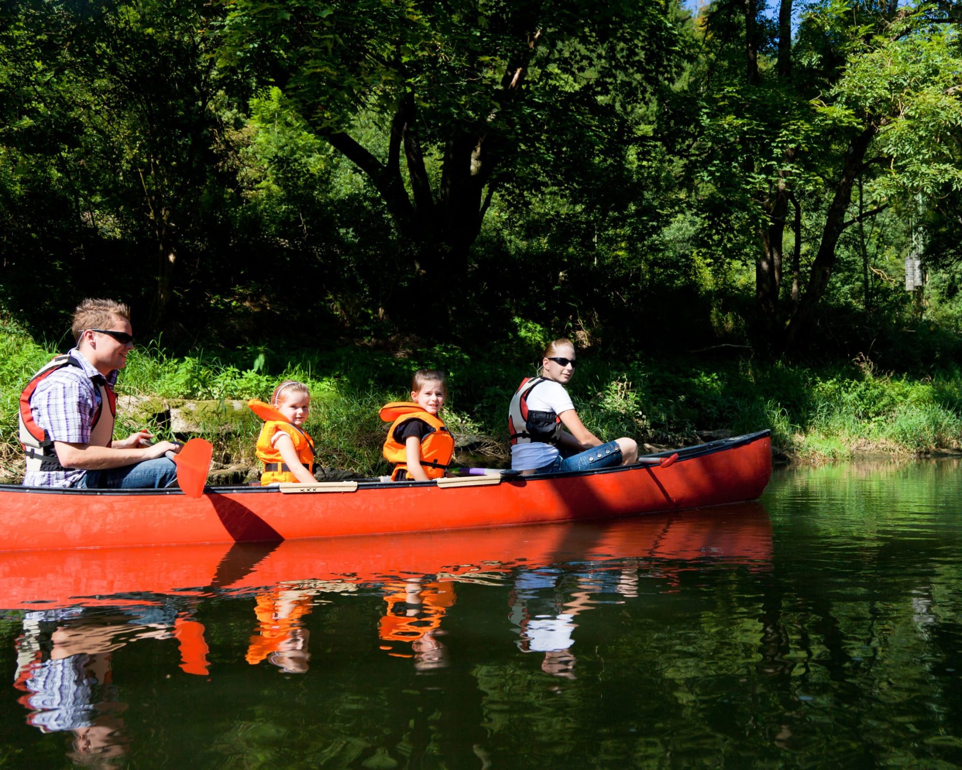 Family enjoying canoeing on the Peconic River near Budget Host East End in Riverhead