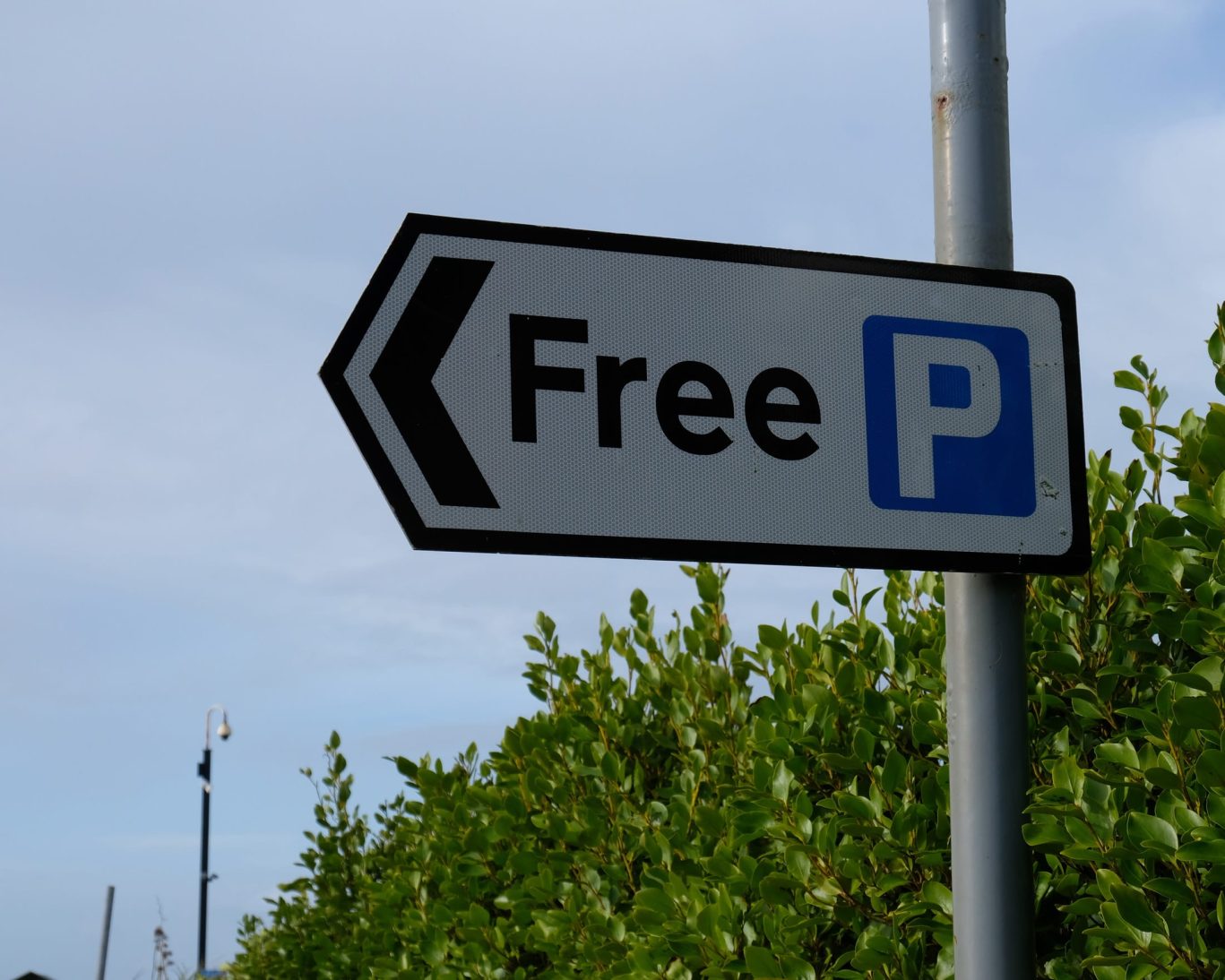 Free parking signage at Budget Host East End near lush greenery