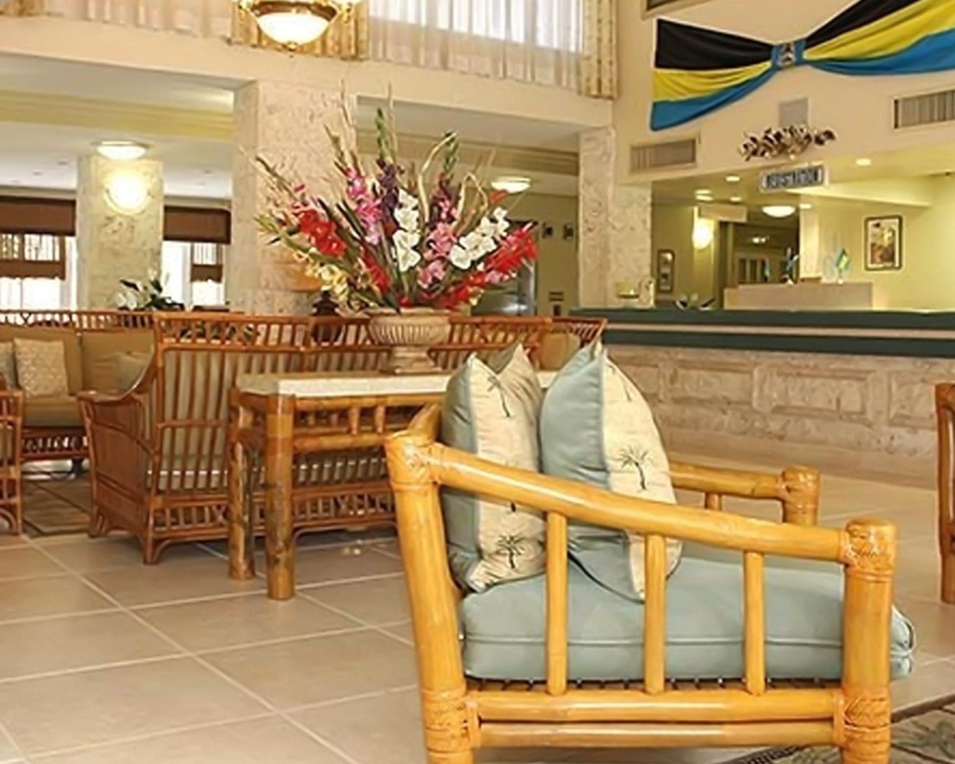 Tropical-style lobby with bamboo furniture and vibrant floral arrangements at Castaways Resort.