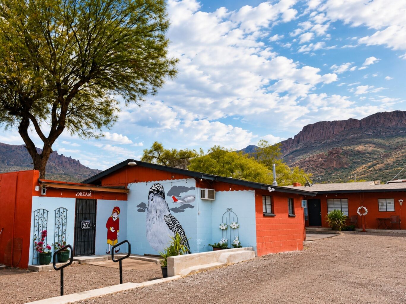 Exterior of Copper Mountain Motel rooms with desert landscaping and mountain views.