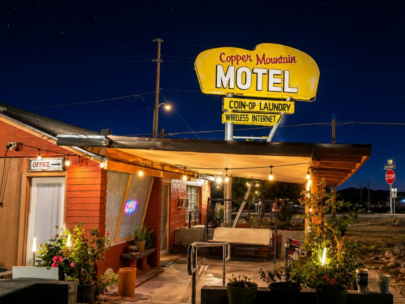 Exterior of Copper Mountain Motel office building night view.