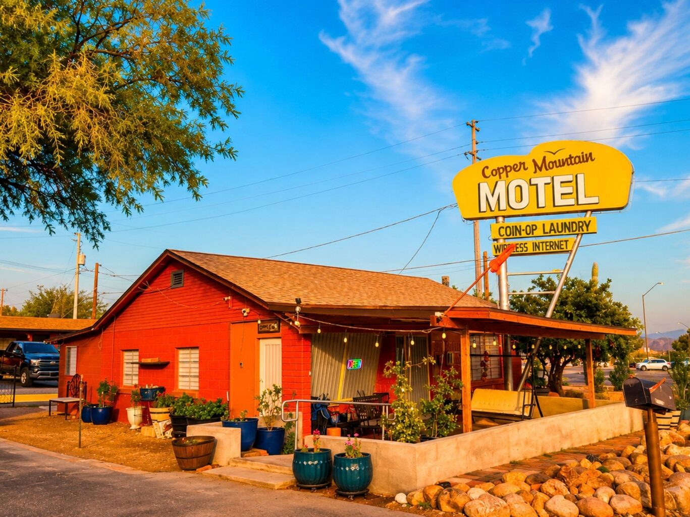 Exterior of Copper Mountain Motel rooms with desert landscaping and mountain views.