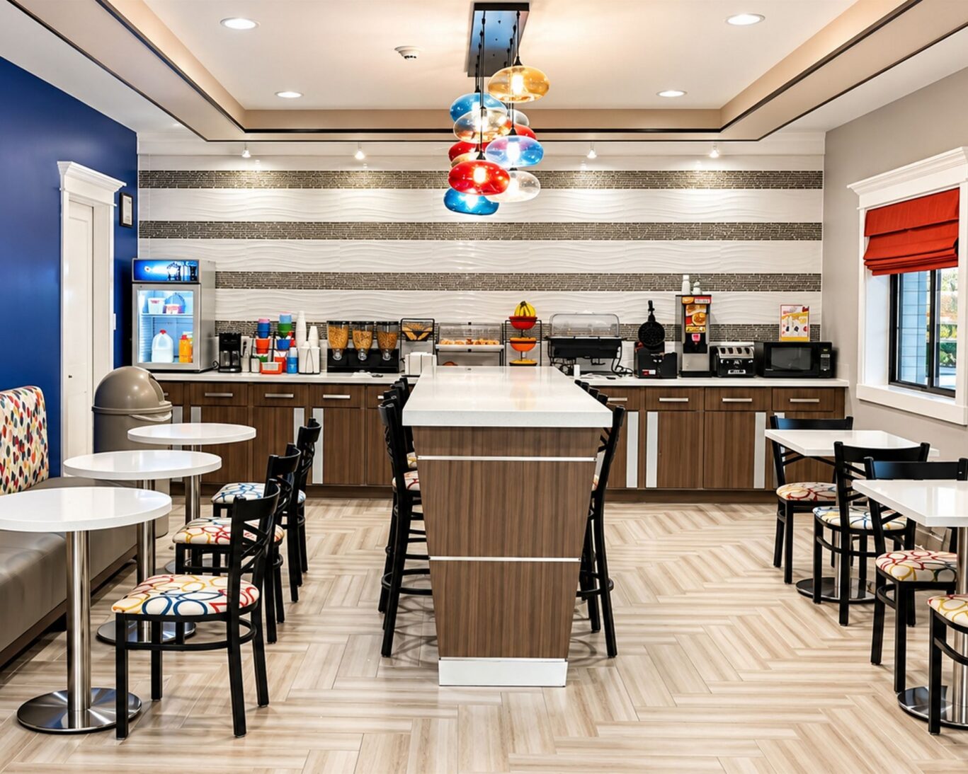 Complimentary breakfast area at Executive Inn & Suites with dining tables, cereal bar, and coffee station.