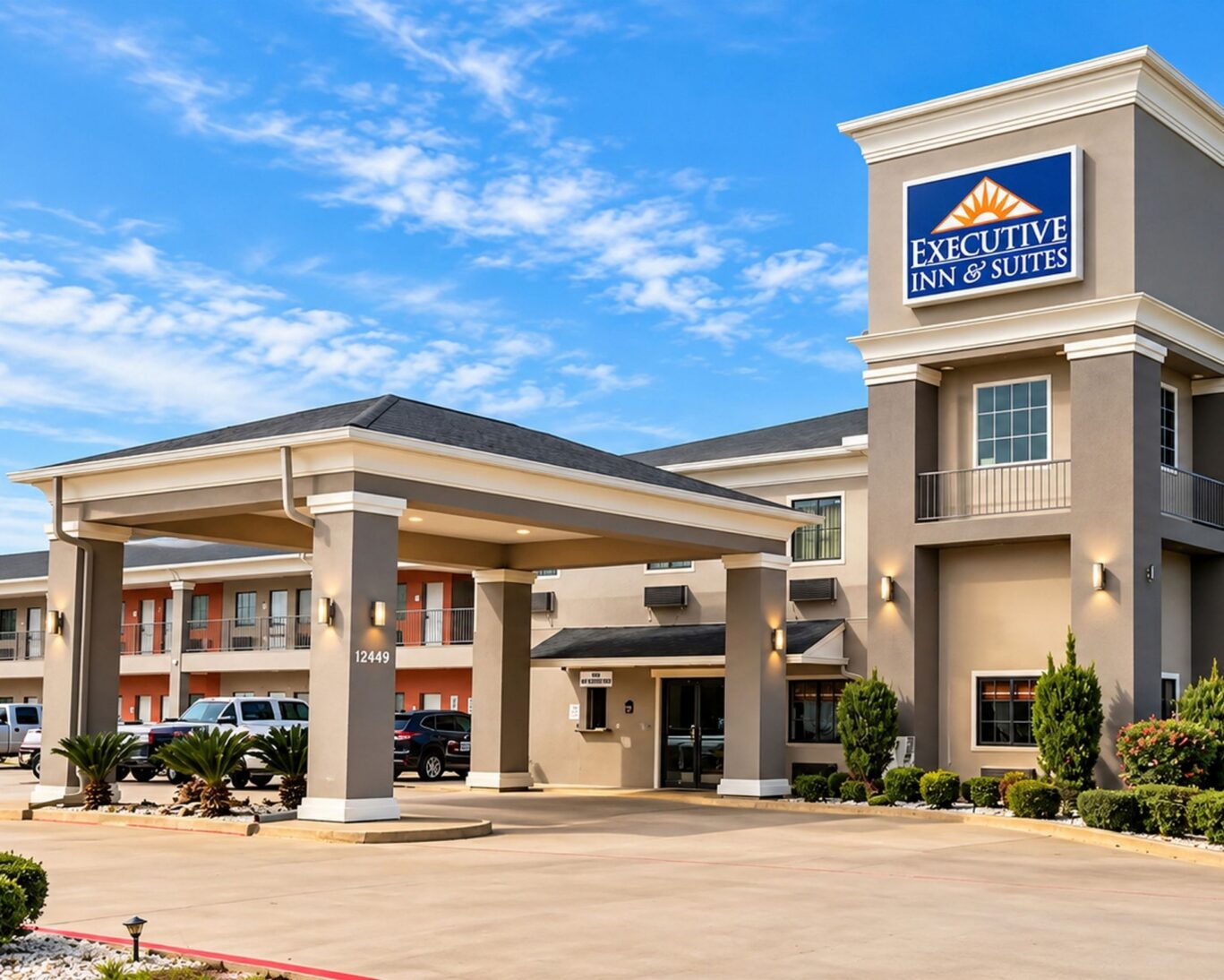 Executive Inn & Suites exterior with welcoming entrance and guest parking.