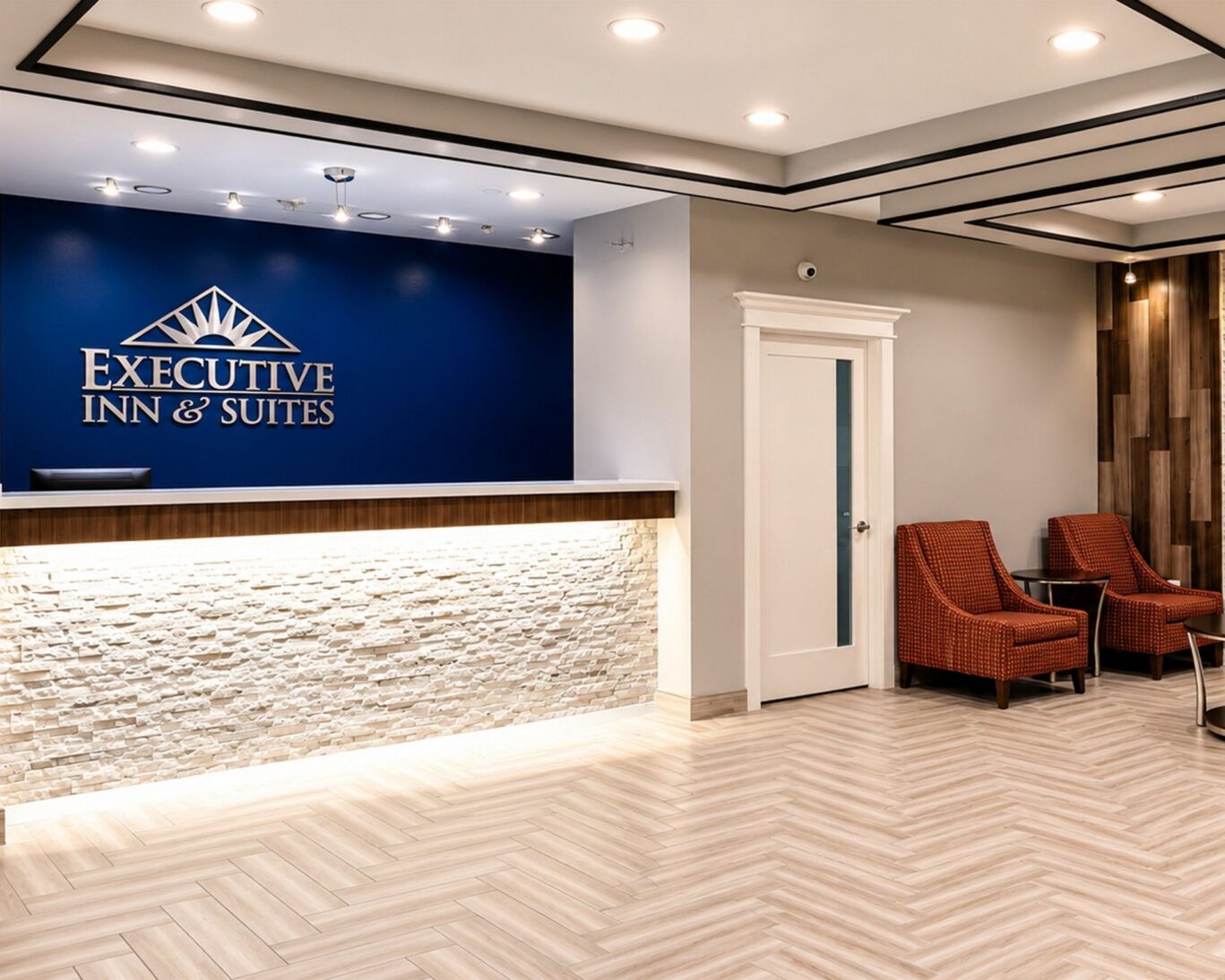Modern hotel lobby at Executive Inn & Suites featuring stylish reception desk.