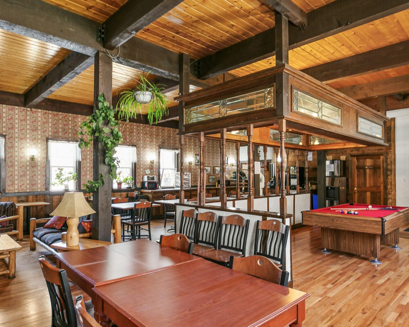 Spacious guest lounge with pool table, wood accents, and vintage charm at Georgetown Lodge.