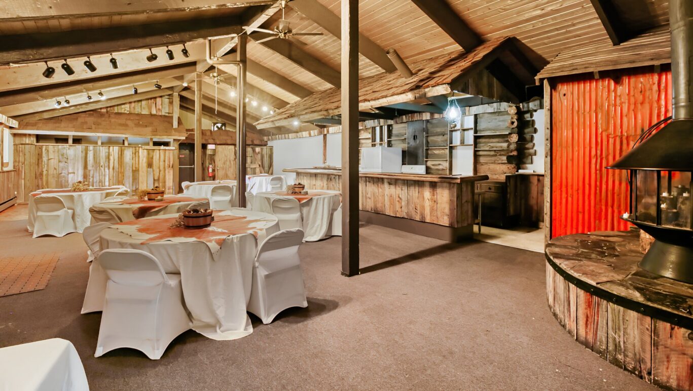 Rustic event space at Georgetown Lodge with banquet tables, wood interiors, and fireplace.