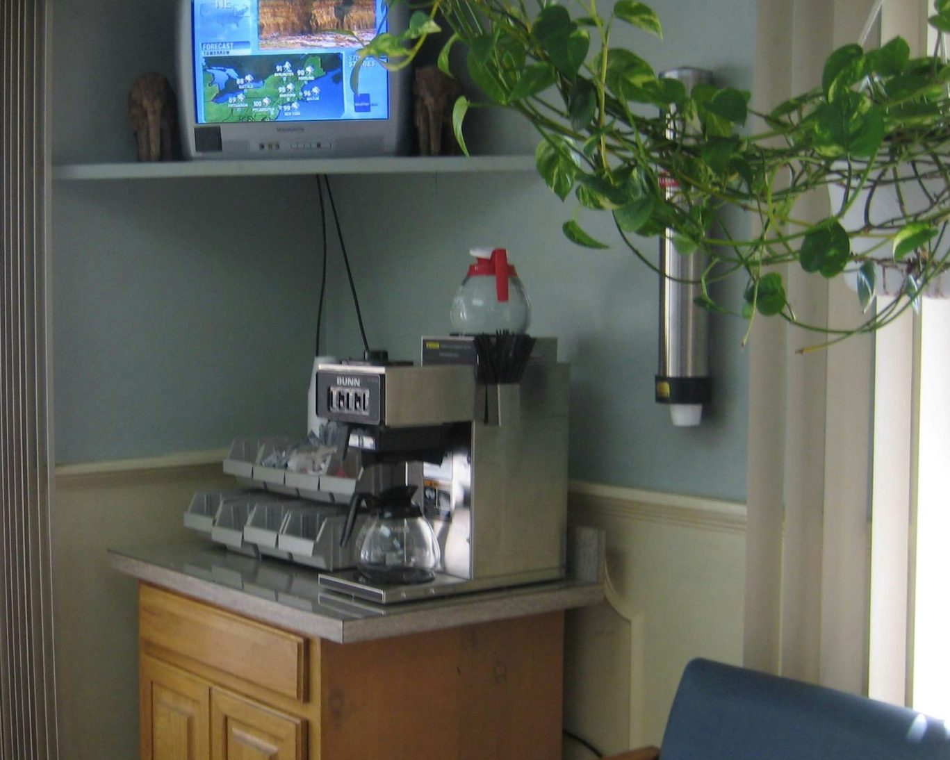Lobby coffee station with television and Bunn coffee machine at Guest House Motel.