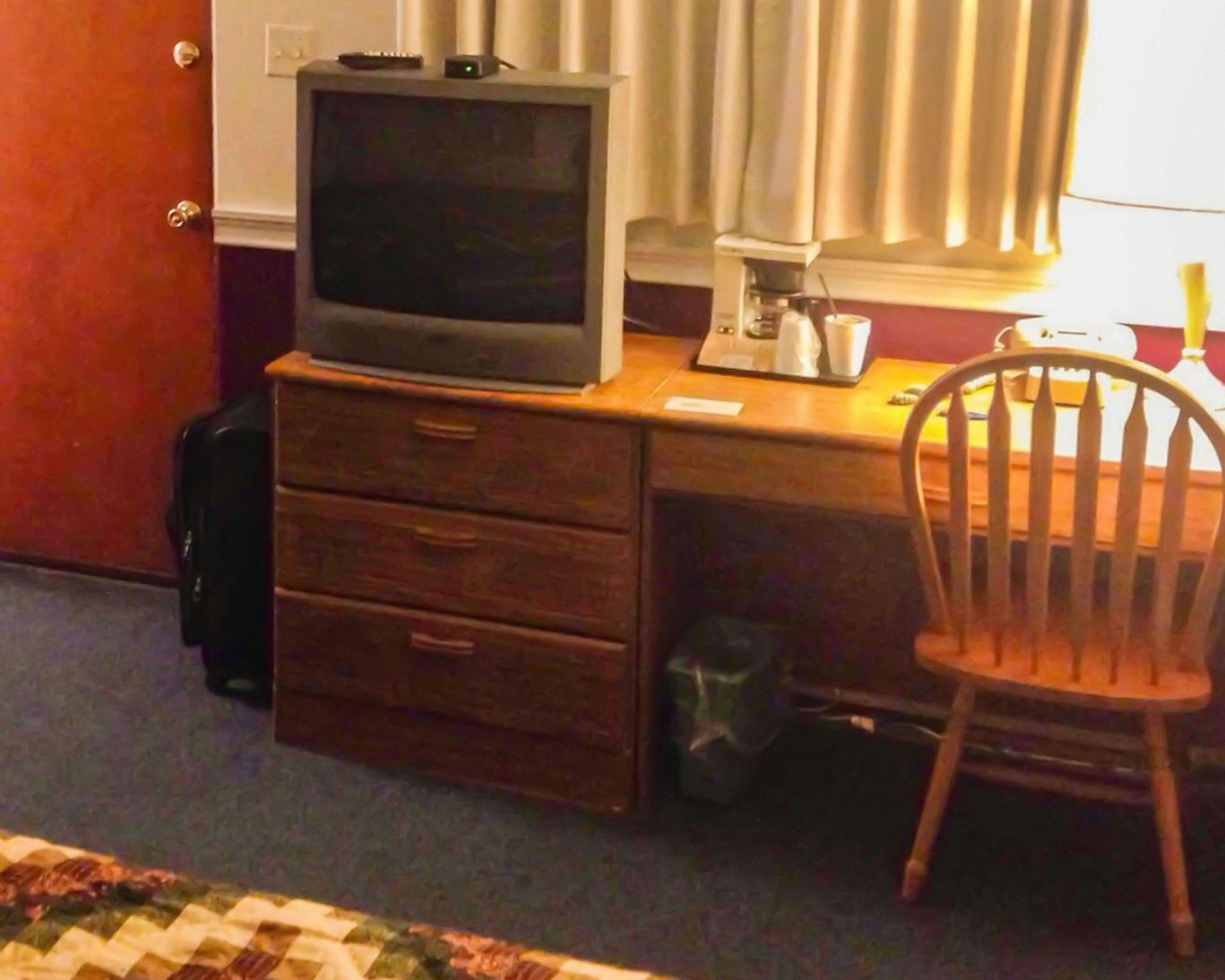 In-room amenities at Judy's Motel Bedford PA including TV, coffee maker, and work desk.