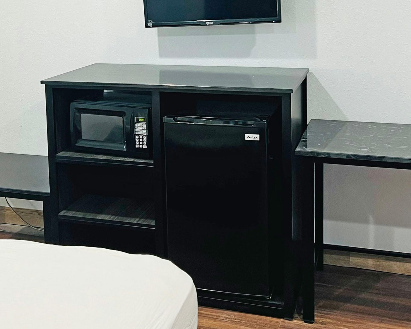 Lanai Motel guest room amenities including microwave, mini fridge, and flat-screen TV.