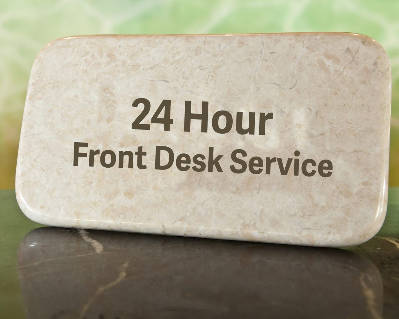 Marble desk sign showing '24 Hour Front Desk Service' at Hampton motel reception.