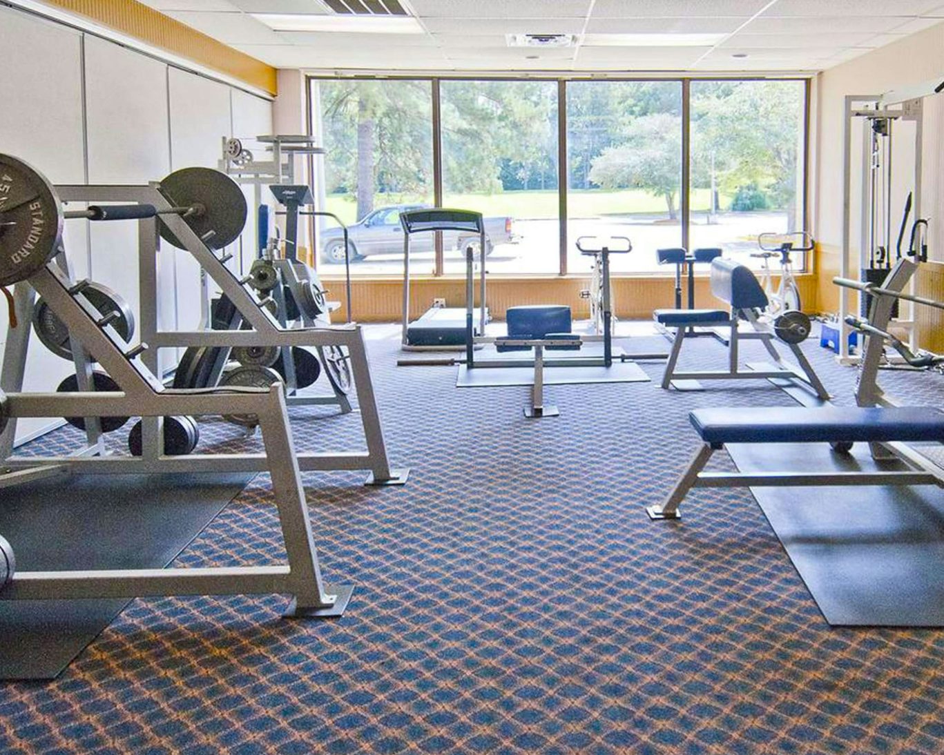 Fully equipped fitness center at The Hotel Francis with cardio machines and weight training equipment.