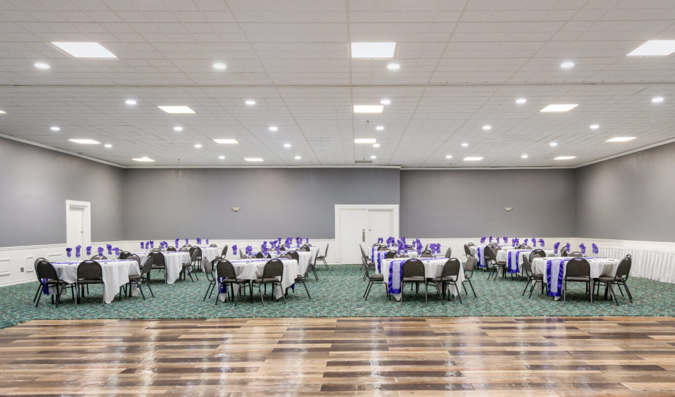 Elegant banquet and event hall at Pearl on the Concho Hotel in San Angelo, TX, set up for a formal gathering with purple-themed decor.