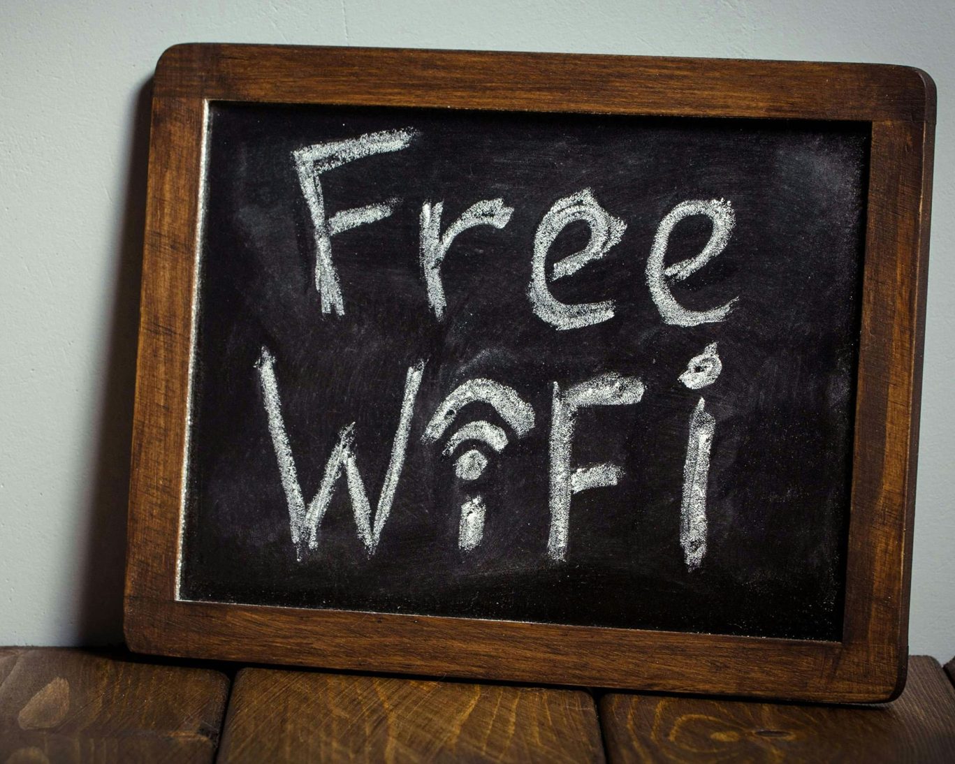 Chalkboard sign inside Relax Inn Bloomsburg displaying 'Free Wi-Fi' for guests.