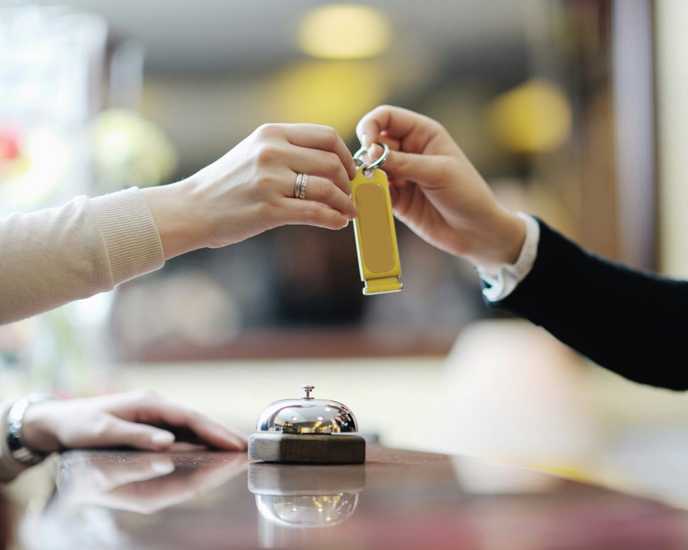 Guest receiving room key at front desk of Rivera Inn & Suites Motel.