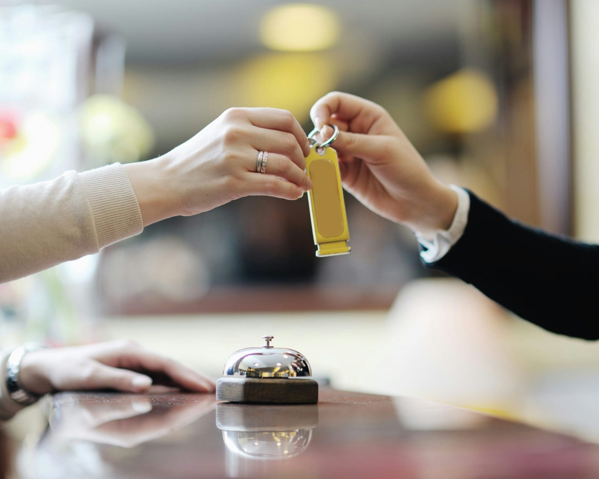 Guest receiving room key at front desk of Rivera Inn & Suites Motel.