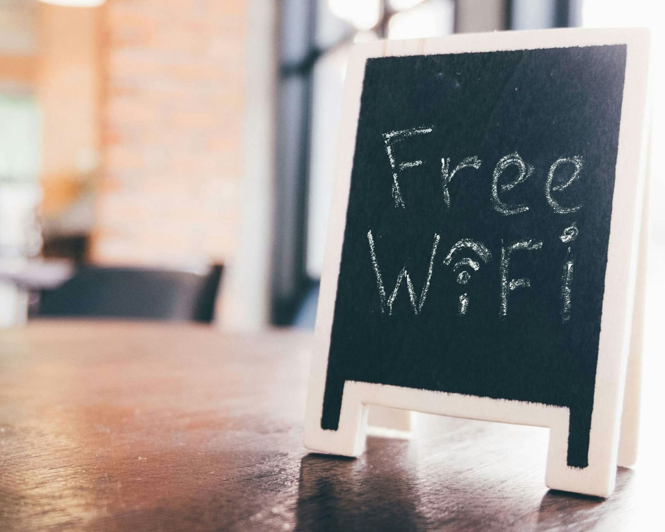 Chalkboard-style tabletop sign reading