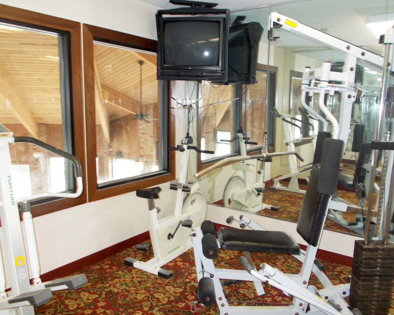On-site fitness center at Royalton Inn & Suites Wilmington with exercise bikes and weight machines.