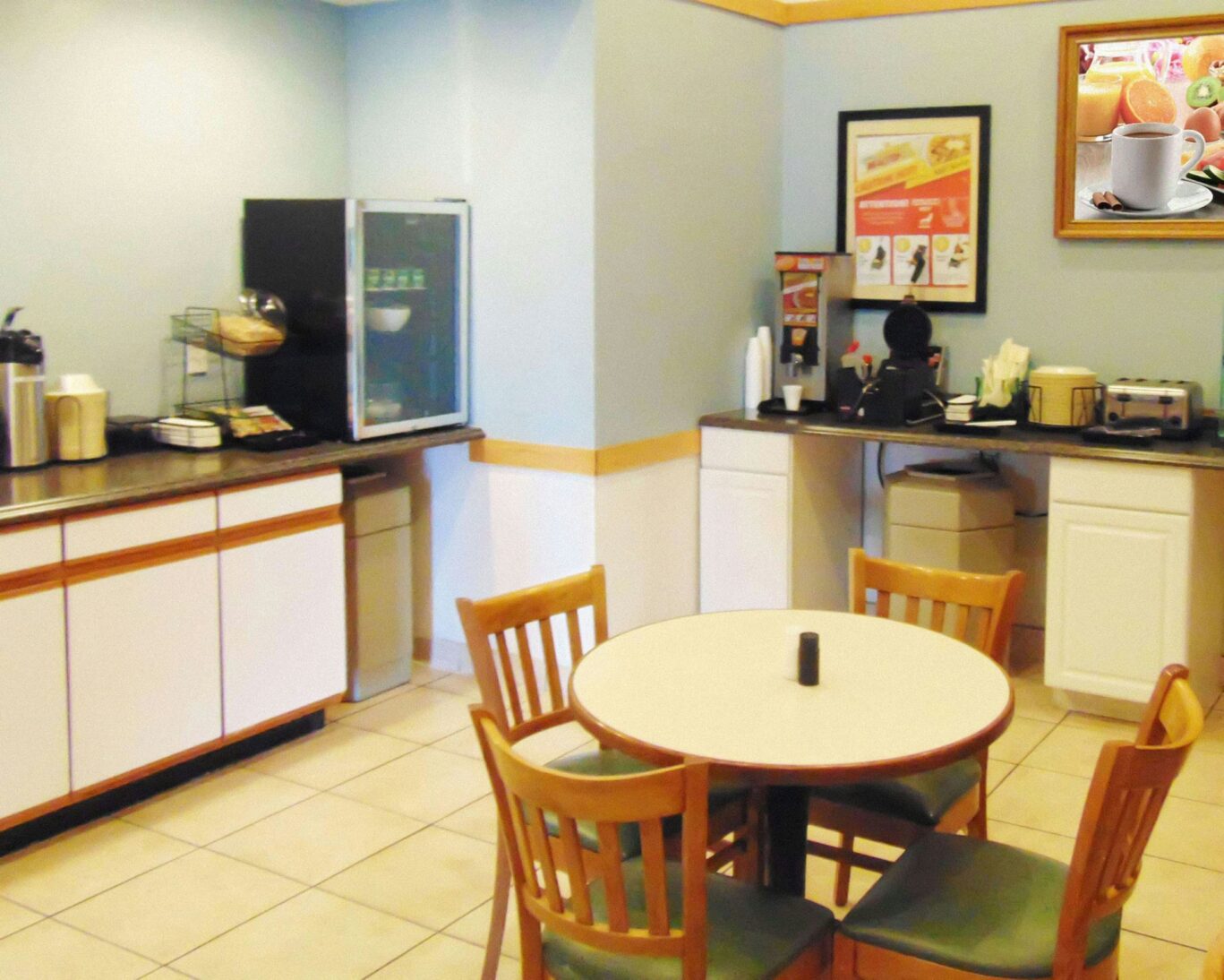 Tava Motel Manitou Springs breakfast area with coffee station and dining table setup.