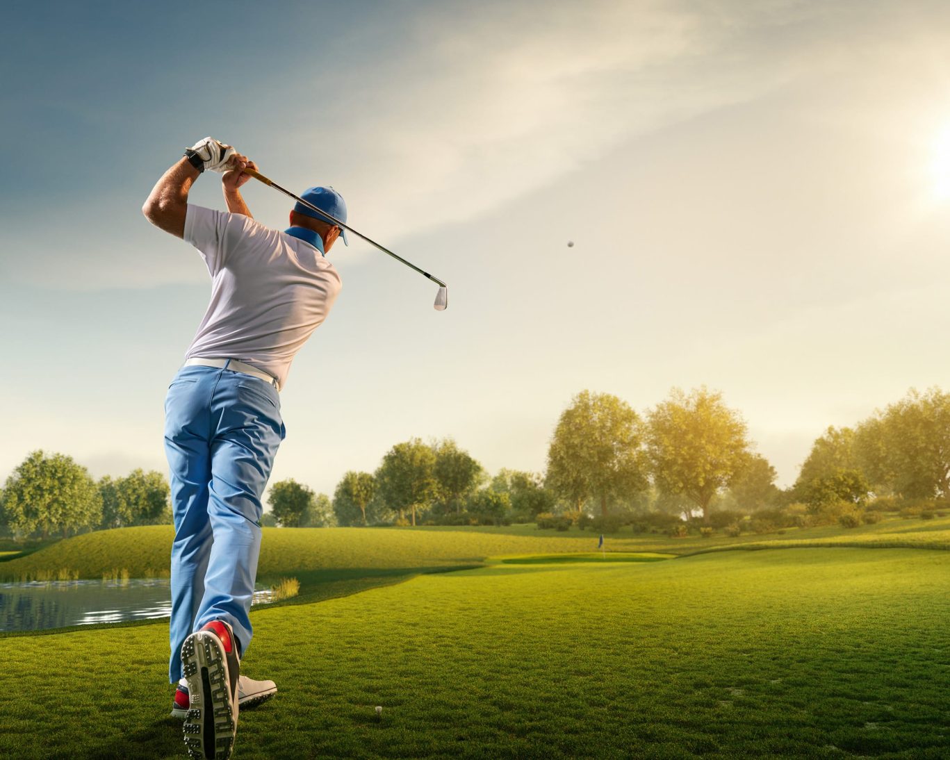 Golfer teeing off at Peninsula Golf & Country Club in San Mateo