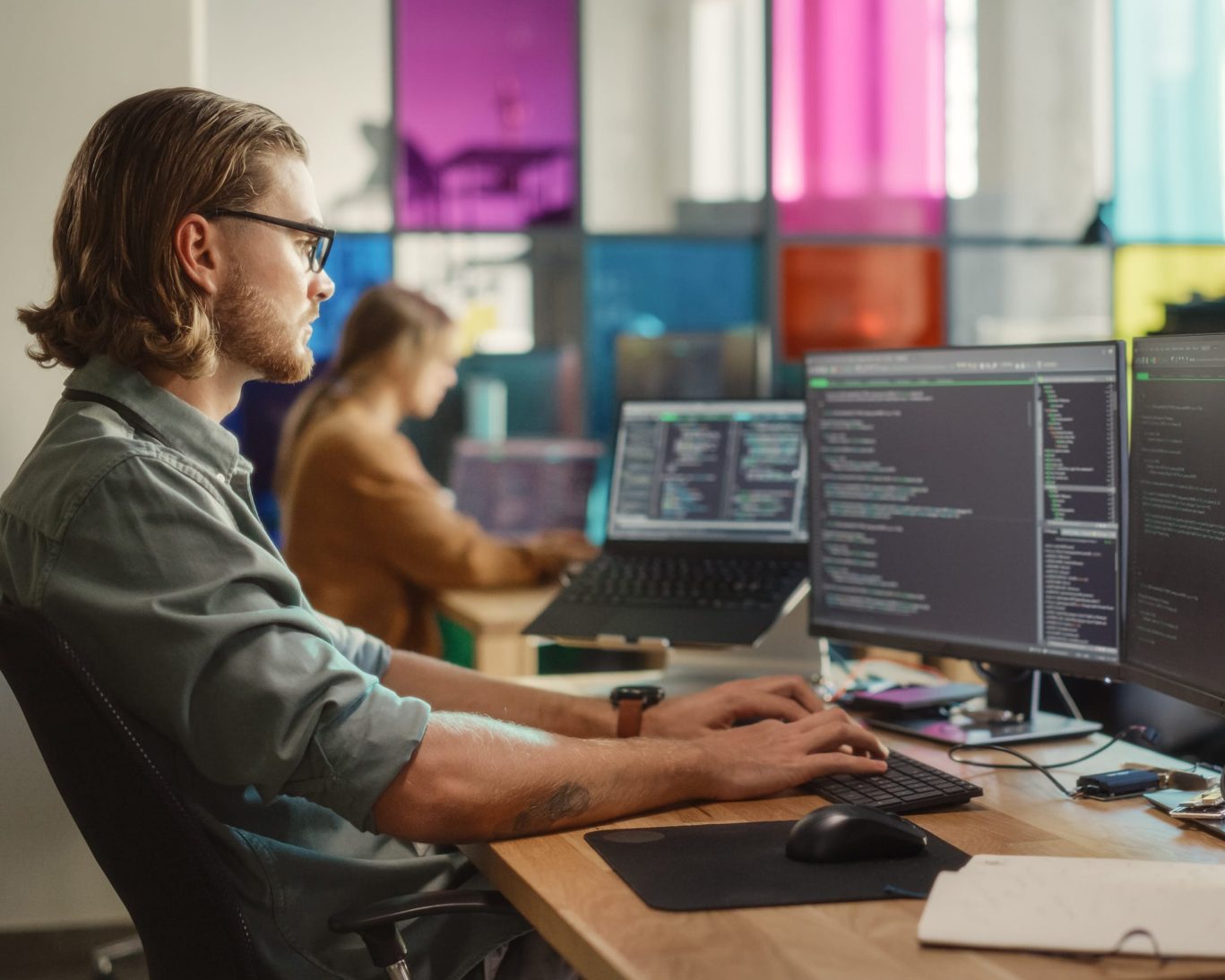 Young developer coding at tech office in San Mateo, California