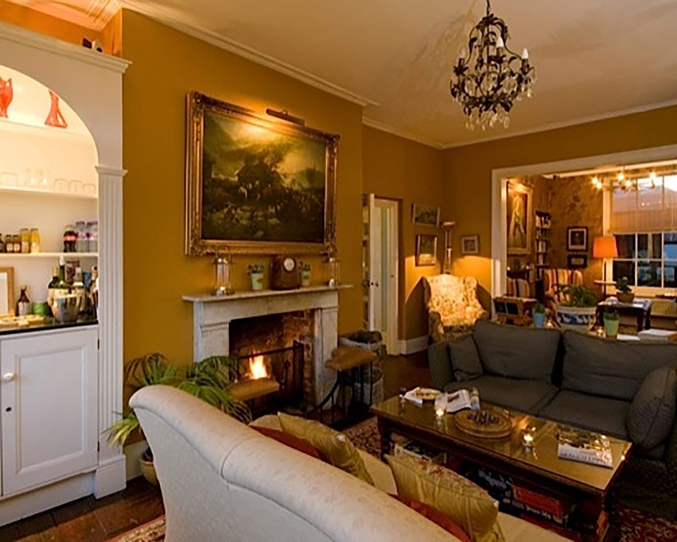 Cosy lounge at The Royal Harbour Hotel Ramsgate with fireplace, vintage décor, and soft lighting.