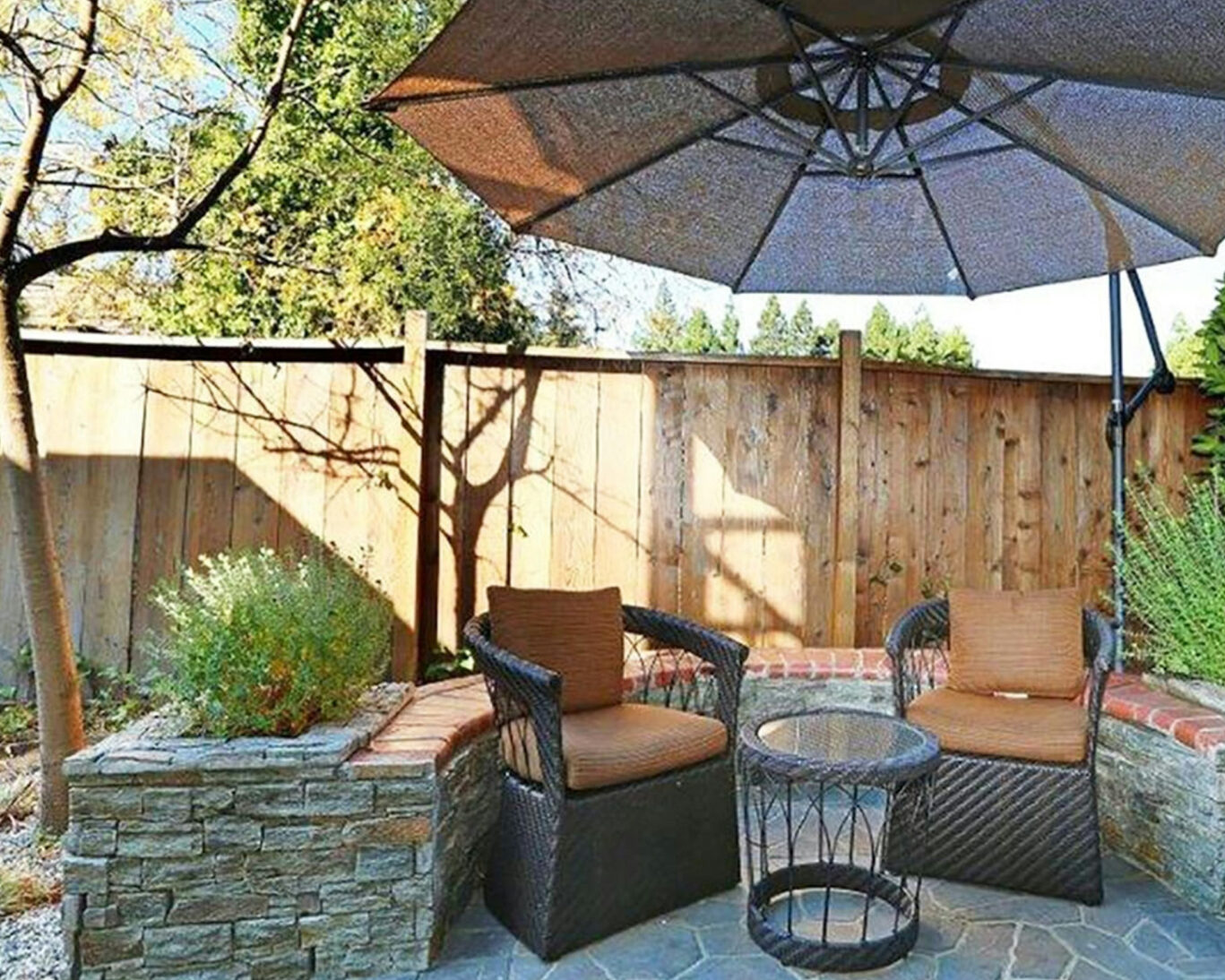 Outdoor patio seating area with umbrella at Zen Hotel in Palo Alto, ideal for relaxation