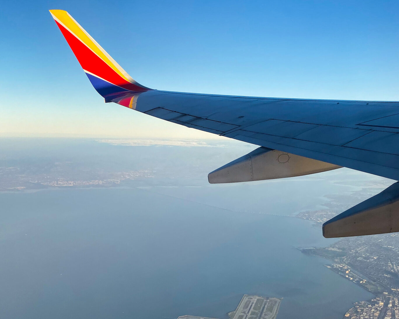 Airplane wing over San Francisco Bay near SFO Airport arrival