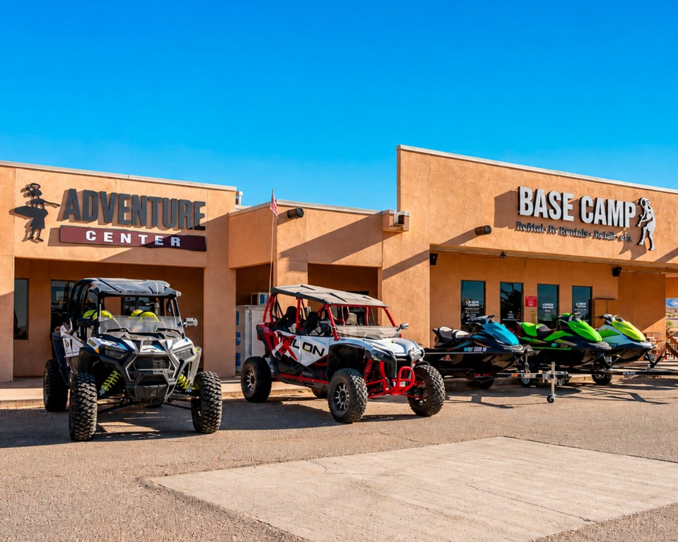 ATVs and jet skis parked in front of Base Camp Adventure Center at Ticaboo Lodge, Utah.