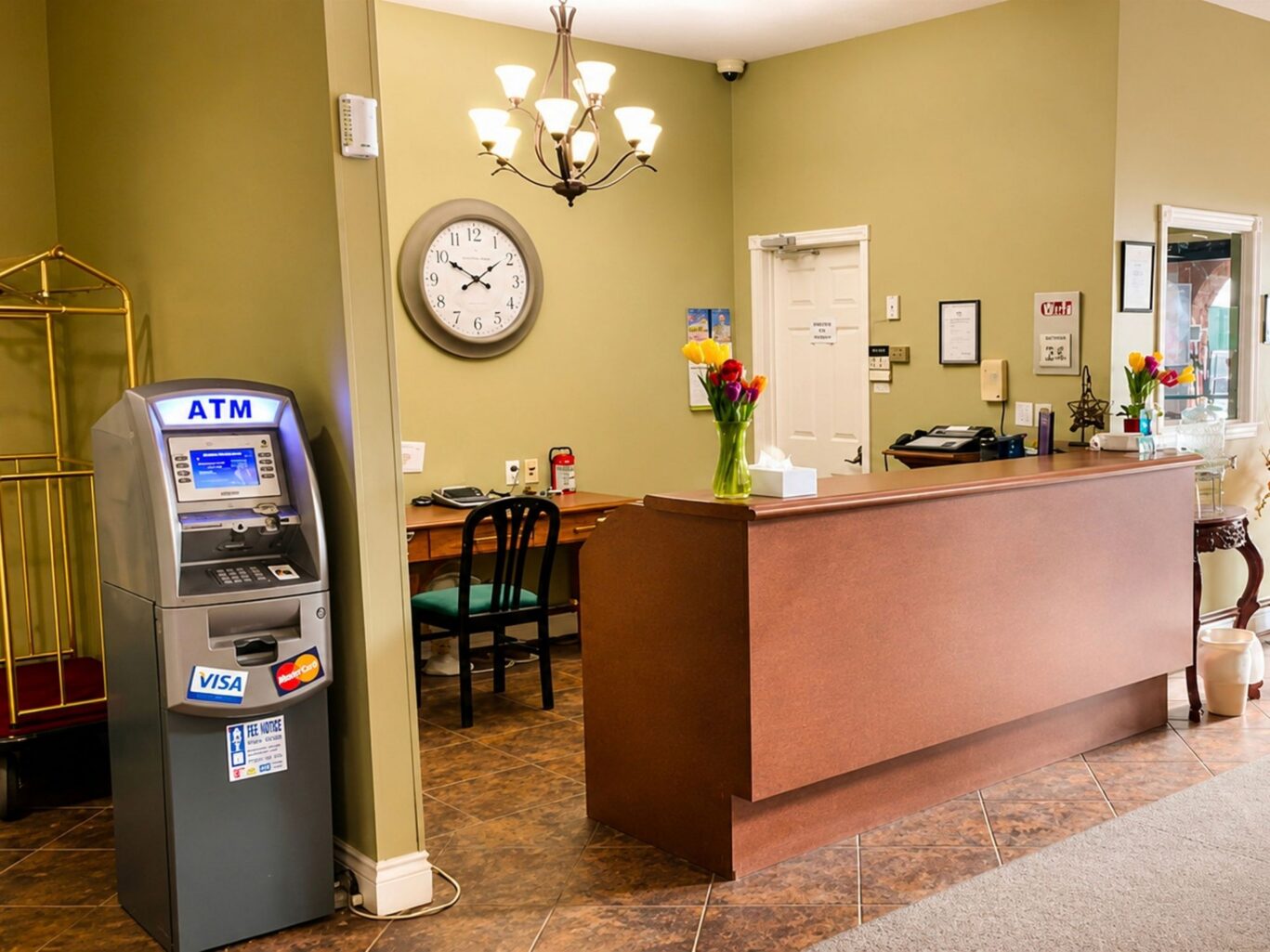 Front desk and reception area at Travellers Inn Summerside with decorative wall art and welcoming ambiance.