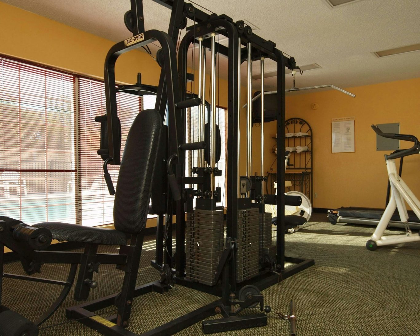On-site fitness center at Western Motel Fitzgerald featuring weight machine and cardio equipment