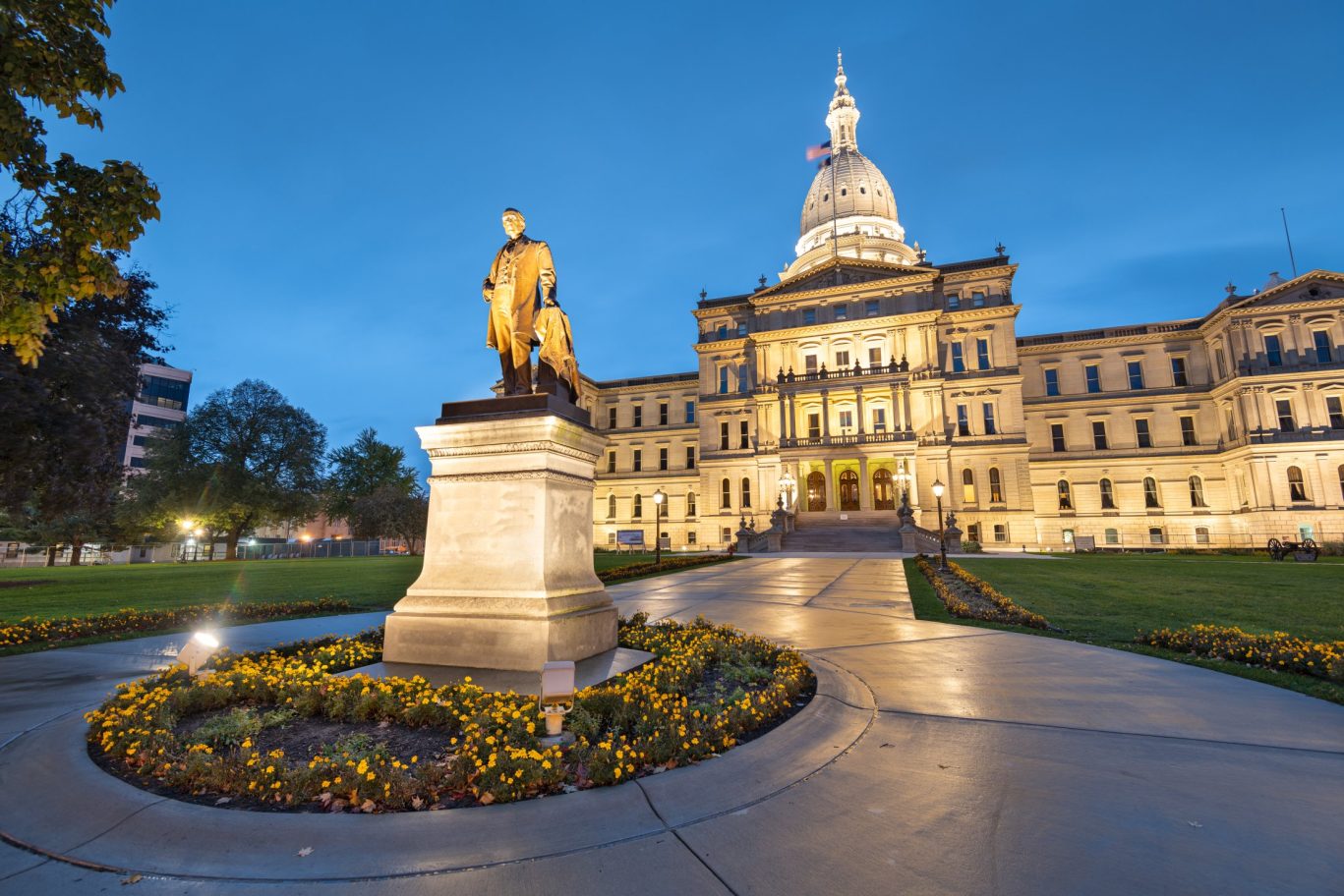 Illuminated Michigan State Capitol building at dusk in Lansing.