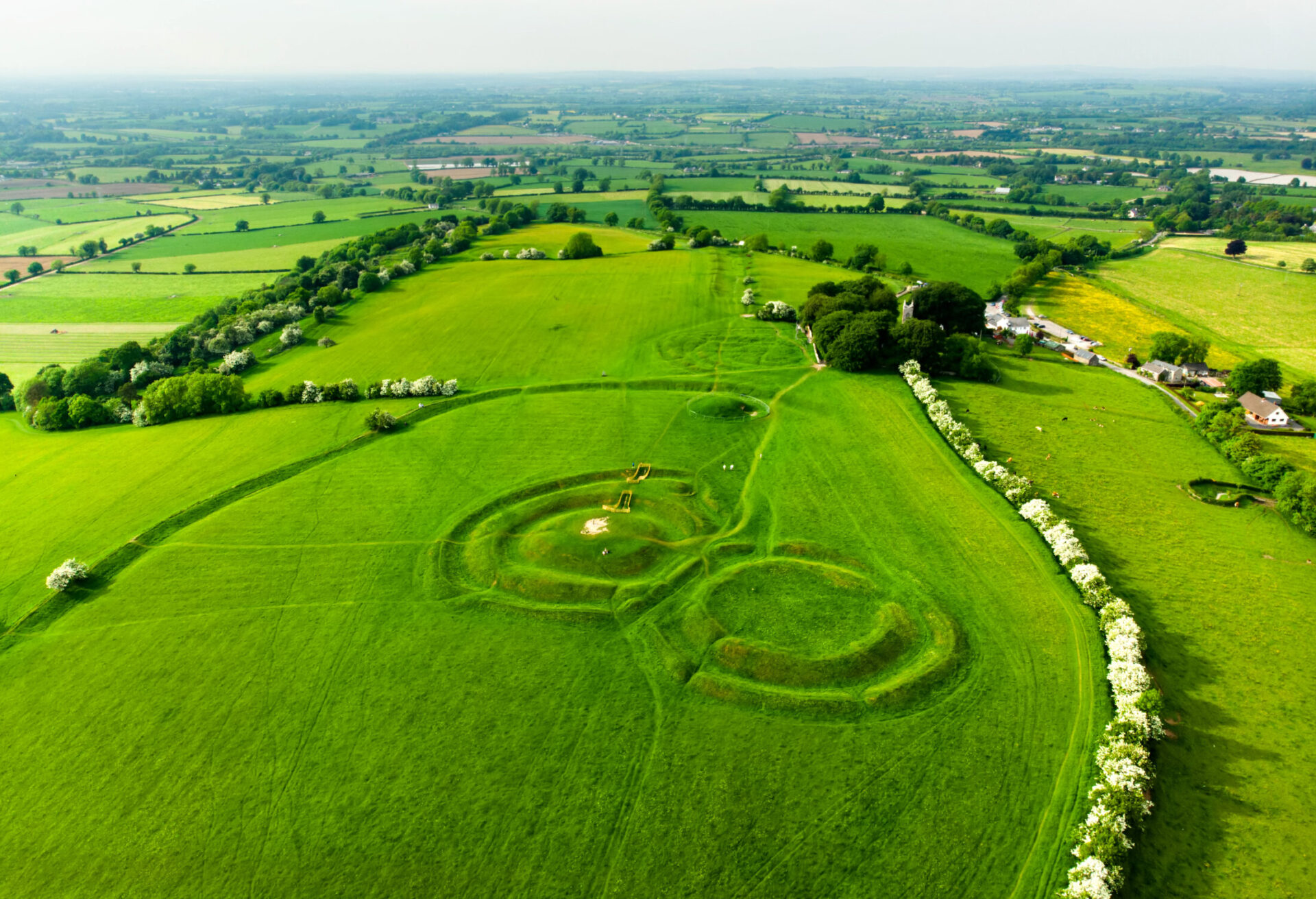 Aerial view of the Hill of Tara archaeological site with ancient earthworks in lush green fields of County Meath, Ireland