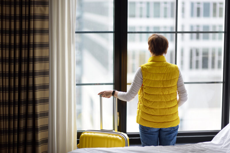 Woman tourist stays in hotel room.