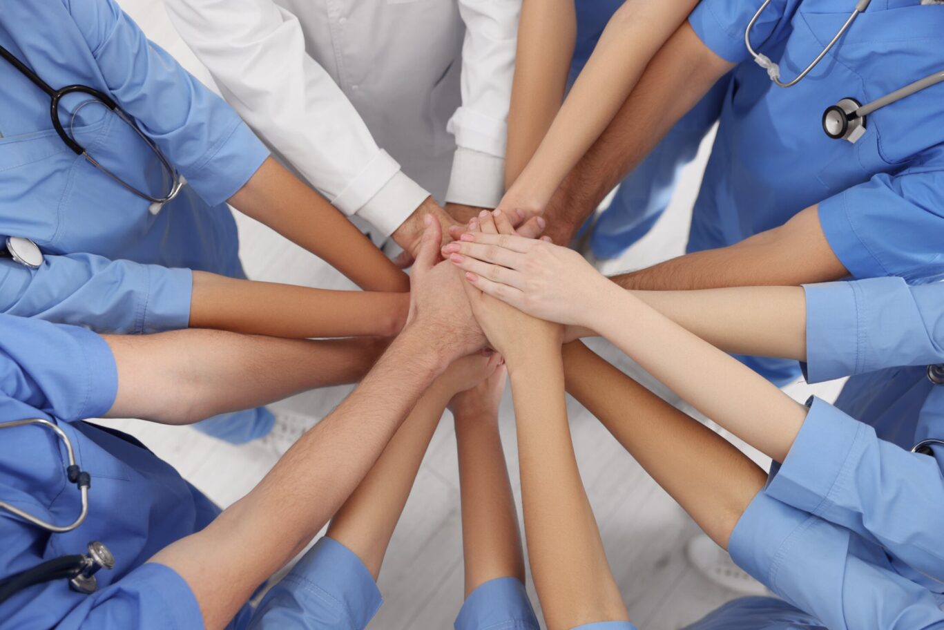 nurses teamwork stacking hands